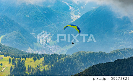 Paraglider flying above mountains, Dolomites, Italy Paraglider flying above mountains, Dolomites, Italy 59272322