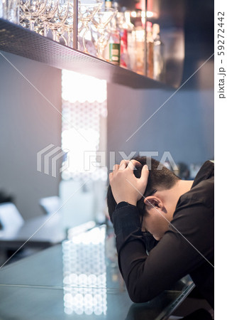 Asian Businessman feeling hangover at the bar Asian Businessman feeling hangover at the bar 59272442