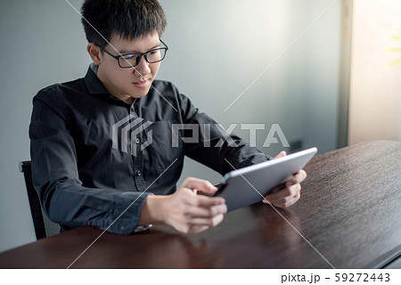 Asian businessman using digital tablet in office 59272443