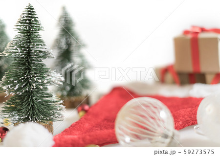 Christmas background with Christmas ball, gift boxes, tree and santa hat on white background Christmas background with Christmas ball, gift boxes, tree and santa hat on white background 59273575