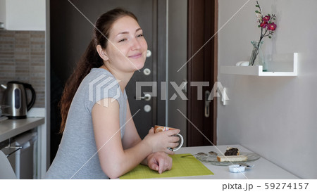 Young woman traveler is having a breakfast in hotel room. Young woman traveler is having a breakfast in hotel room. 59274157