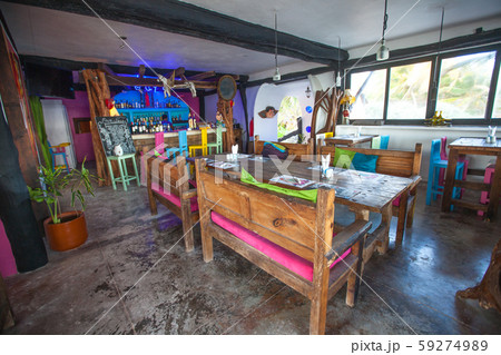 Bright colored bar-restaurant on the white sandy beach in Tulum 59274989