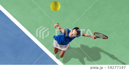 Young woman in blue shirt playing tennis. Youth, flexibility, power and energy. 59277197