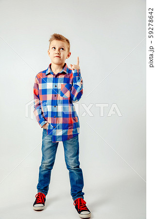 Boy wearing colorful plaid shirt, blue jeans, gumshoes, pointing up isolated. copyspase. Boy wearing colorful plaid shirt, blue jeans, gumshoes, pointing up isolated. copyspase. 59278642