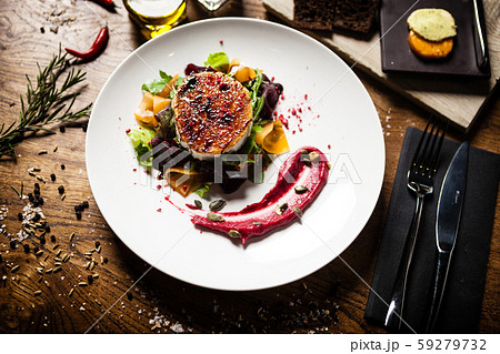 Grilled goat cheese salad served on a plate in restaurant Grilled goat cheese salad served on a plate in restaurant 59279732