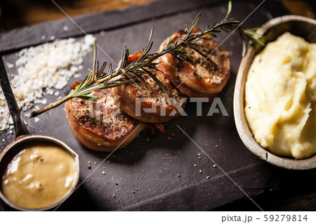 Pork tenderloin served on a board in restaurant 59279814