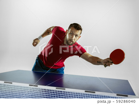 Young man playing table tennis on white studio background Young man playing table tennis on white studio background 59286040
