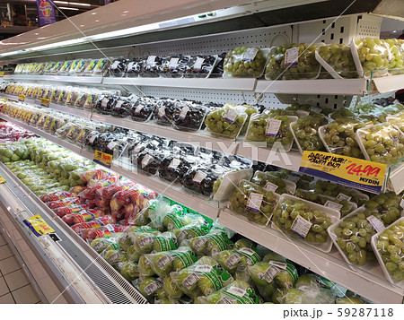 Fruits packed inside plastic container and plastic wrap. Displayed for sale on the cool chiller rack inside the huge supermarket. Fruits packed inside plastic container and plastic wrap. Displayed for sale on the cool chiller rack inside the huge supermarket. 59287118