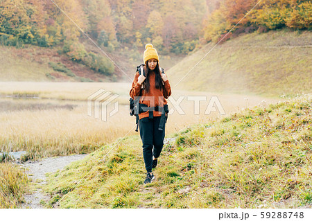 A woman walking with a backpack 59288748