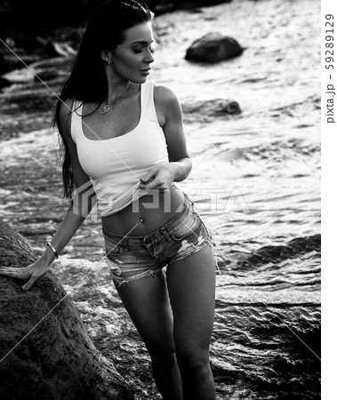 Young beautiful woman posing on a beach 59289129
