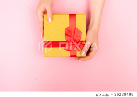 Yellow gift box on a pink background. 59289499