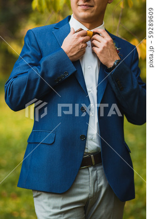 Happy elegant confident man straightening bow tie 59289609