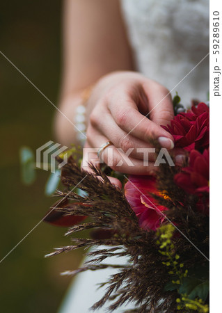 Bride holding bouquet with vinous flowers in 59289610