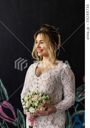 Beautiful woman in wedding dress in photo studio. 59289730