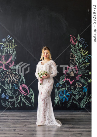 Beautiful woman in wedding dress in photo studio. 59289732