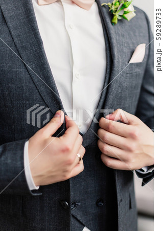 Young handsome man adjusting his jacket. 59289733