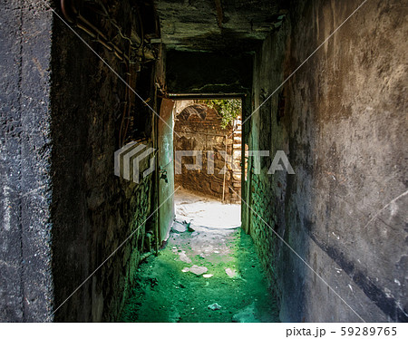 Old abandoned tunnel in the slum underground cellar. Entrance to urban catacombs. Underside of city Old abandoned tunnel in the slum underground cellar. Entrance to urban catacombs. Underside of city 59289765