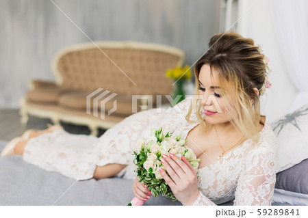 Beautiful woman in wedding dress in photo studio. 59289841