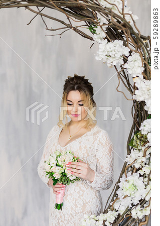 Beautiful woman in wedding dress in photo studio. 59289863