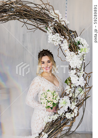 Beautiful woman in wedding dress in photo studio. 59289891