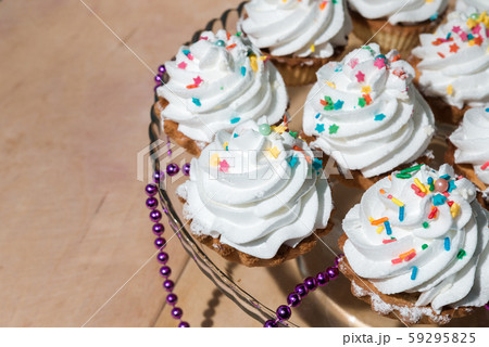 Cakes with white cream and colored powder on a Cakes with white cream and colored powder on a 59295825