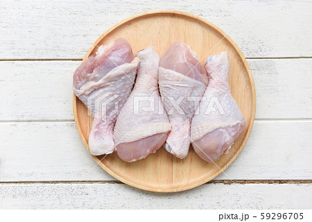 Raw chicken legs on wooden plate / fresh uncooked 59296705