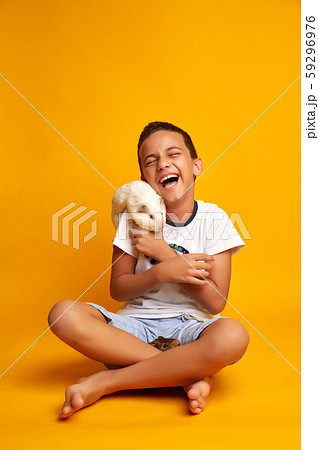 Happy boy playing with cute guinea pigs 59296976