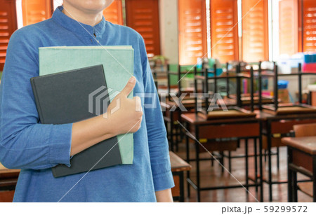 teacher is standing in classroom teacher is standing in classroom 59299572