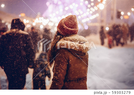 Girl Walking Through Christmas Market In City At Night Girl Walking Through Christmas Market In City At Night 59303279