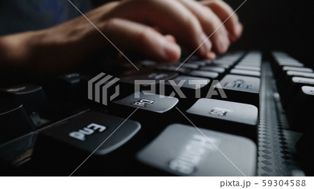 Close-up soft-focus finger typing on keyboard. 59304588