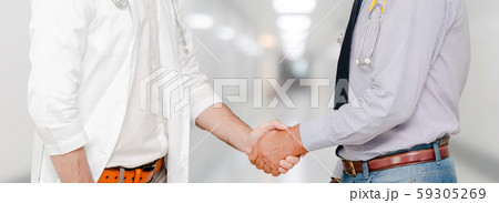 Doctor in hospital handshake with another doctor. Doctor in hospital handshake with another doctor. 59305269