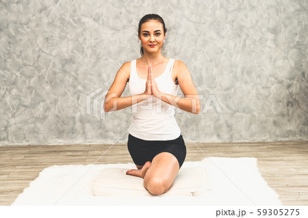Young woman yoga on carpet at home living room. 59305275