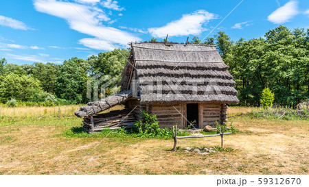 Small shepherd hut with straw roof on sunny day 59312670