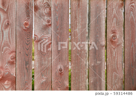 Old picket fence with faded red paint, abstract backdrop texture 59314486