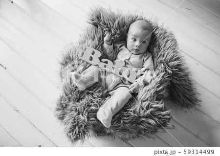 newborn baby wrapped in a blanket sleeping in a basket. concept of childhood, healthcare, IVF. Black and white photo newborn baby wrapped in a blanket sleeping in a basket. concept of childhood, healthcare, IVF. Black and white photo 59314499