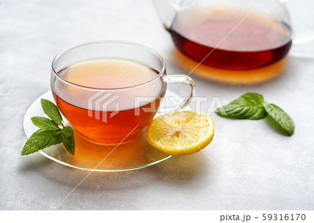 Glass cup of tea and kettle composition Glass cup of tea and kettle composition 59316170