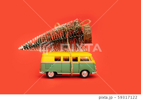 Miniature hippy car with fir tree on red background. minimal new yrar 2020 Miniature hippy car with fir tree on red background. minimal new yrar 2020 59317122