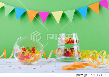 jelly candy in glass bowl on green party background jelly candy in glass bowl on green party background 59317127