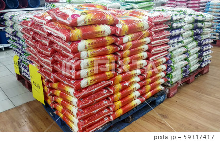 The rice in the plastic packaging is stacked inside the supermarket for sale. Variety of type and price 59317417