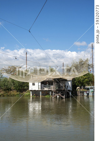 Fishing houses in dock and fishnet. 59320773
