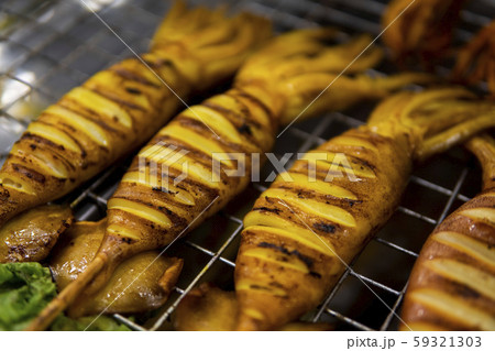 Squid grill on hot charcoal hot fire tasty delicious sea food. Grilled squid on bbq fire. Thai Squid grill on hot charcoal hot fire tasty delicious sea food. Grilled squid on bbq fire. Thai 59321303