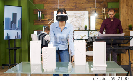 Female architects exploring virtual reality project of business buildings 59321308