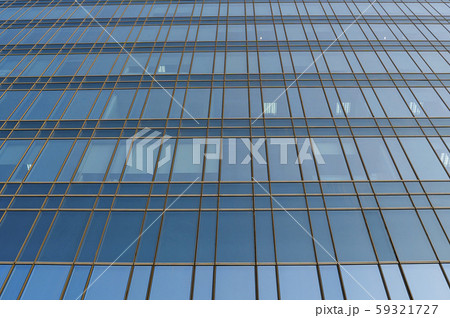 Reflection of the sky in the windows of a building. Perspective and underdite angle view to modern 59321727