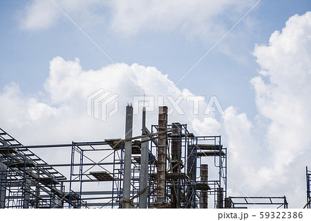 Building and Construction Site in progress. Building construction site against cloudy sky. Metal Building and Construction Site in progress. Building construction site against cloudy sky. Metal 59322386