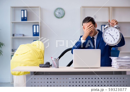 Young father looking after newborn in the office Young father looking after newborn in the office 59323077