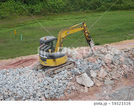 Concrete hacking heavy machine used to crush concrete to small pieces at the construction site in Malaysia. Concrete hacking heavy machine used to crush concrete to small pieces at the construction site in Malaysia. 59323316