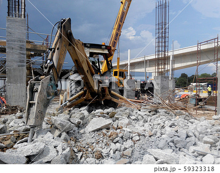 Concrete hacking heavy machine used to crush concrete to small pieces at the construction site in Malaysia. Concrete hacking heavy machine used to crush concrete to small pieces at the construction site in Malaysia. 59323318
