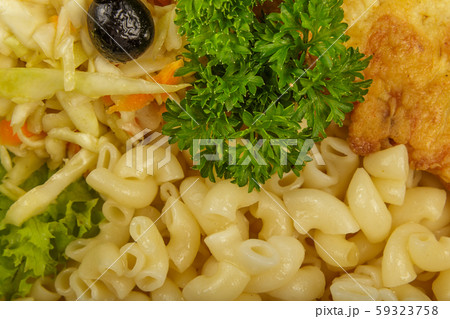 Pasta with a piece of grilled meat and salad. 59323758