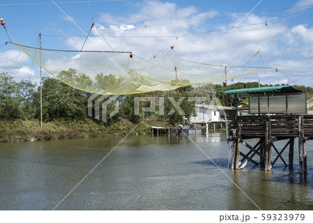 Fishing houses in dock and fishnet. Fishing houses in dock and fishnet. 59323979