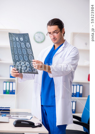 Young male doctor working in the clinic Young male doctor working in the clinic 59323984